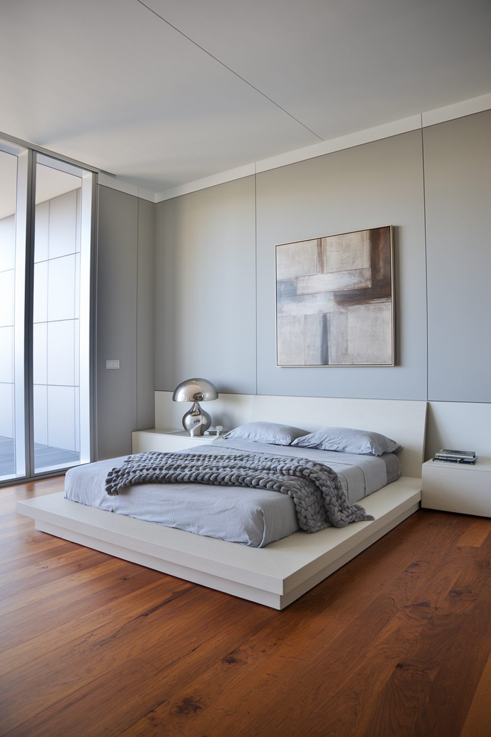 light gray walls with cherry wood floors for a sleek modern bedr