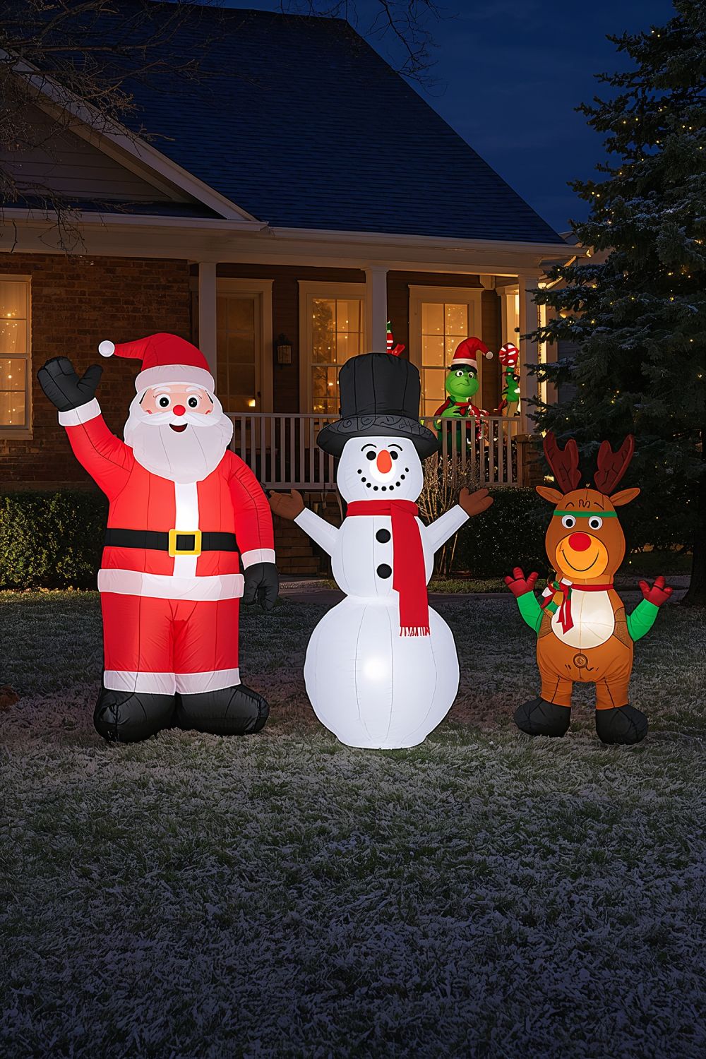 Inflatable Christmas Characters Display In Front Yard At Night