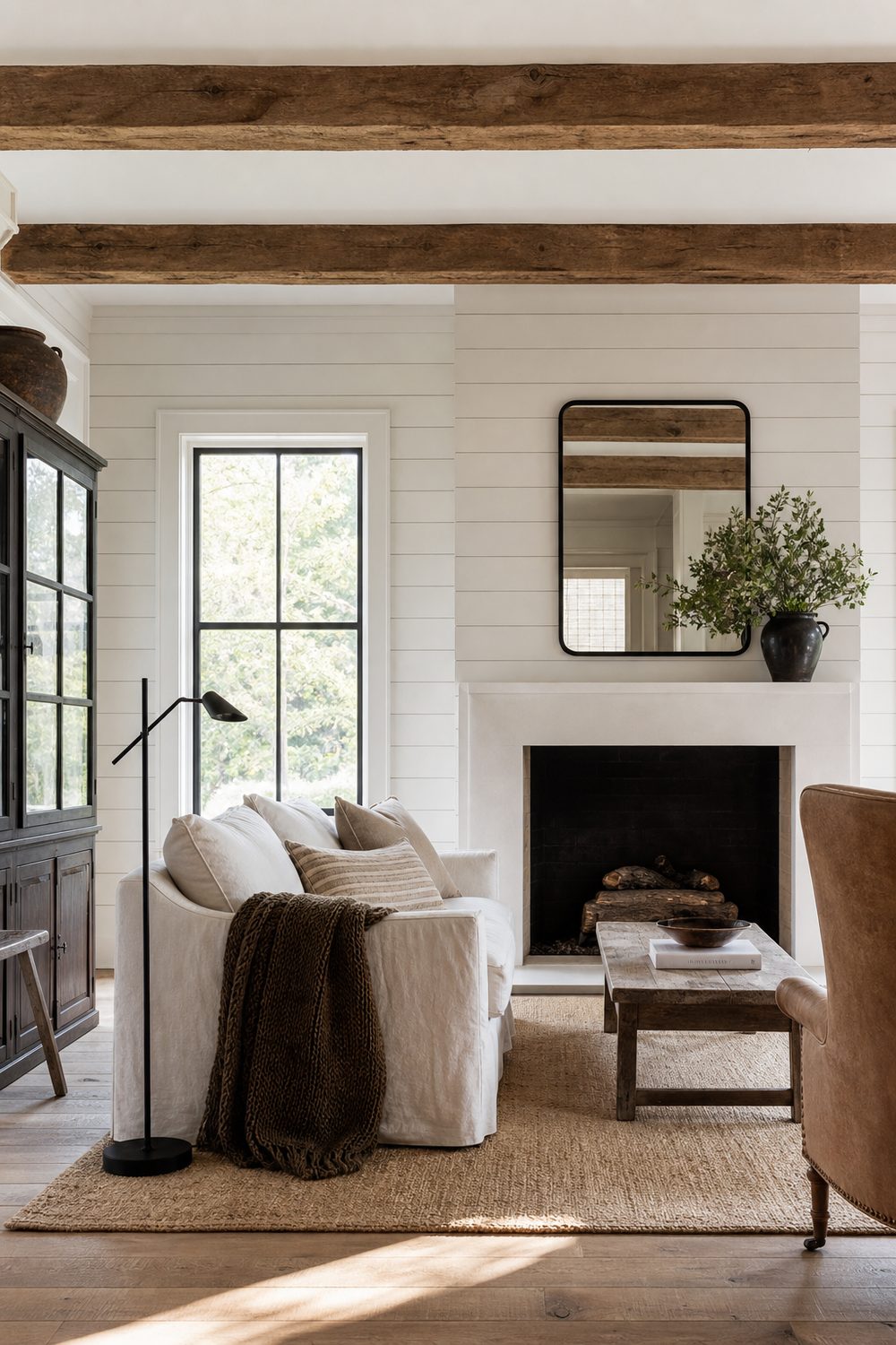 Modern Farmhouse style living room with shiplap and warm oak beams, editorial interior photography