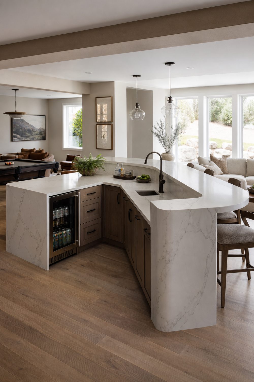 Wraparound L-shaped basement bar with a prep leg, seating leg, beverage fridge and rounded corner