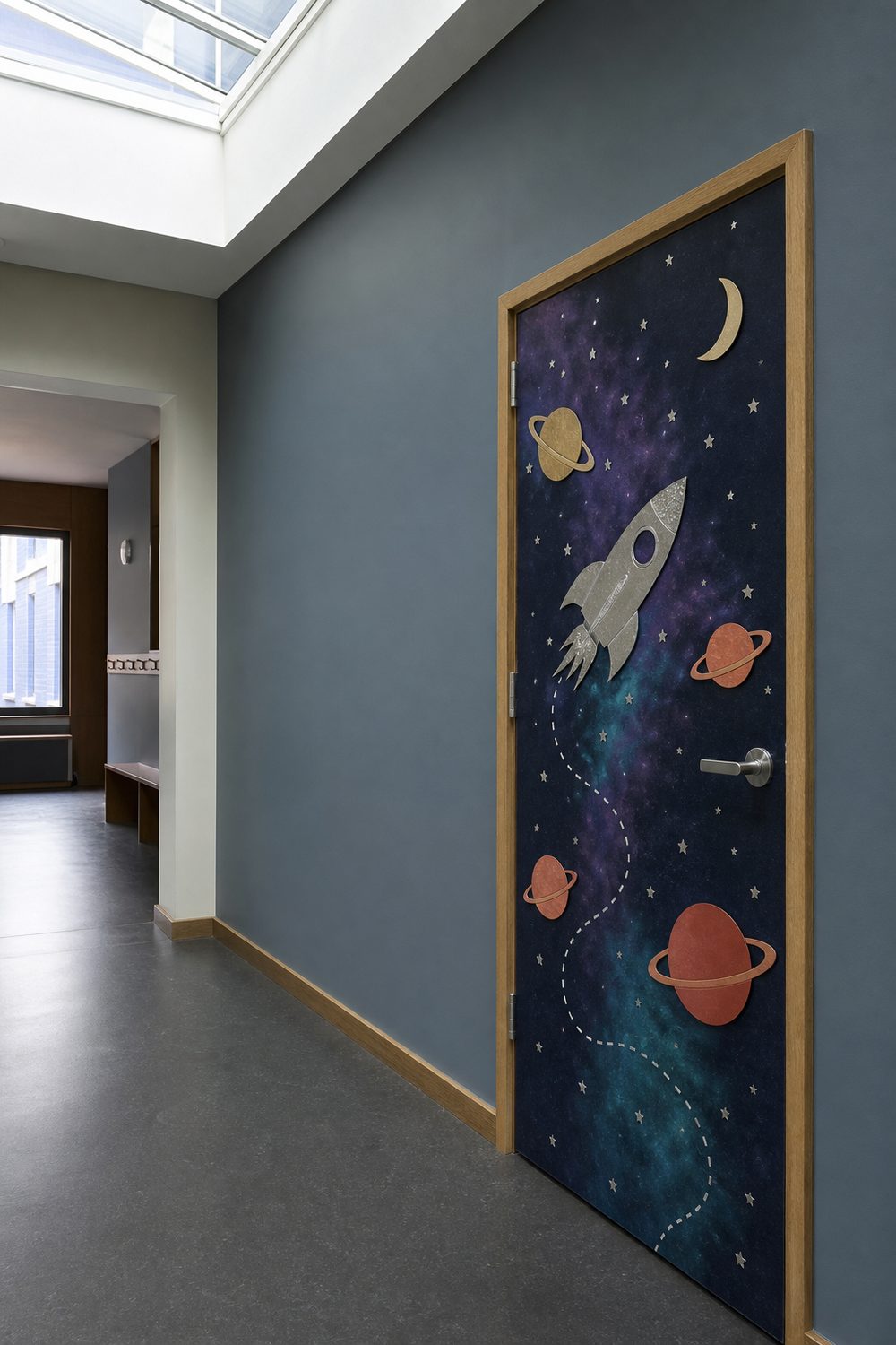 Space themed classroom door with indigo nebula background, ringed paper planets, silver foil rocket, and metallic star confetti